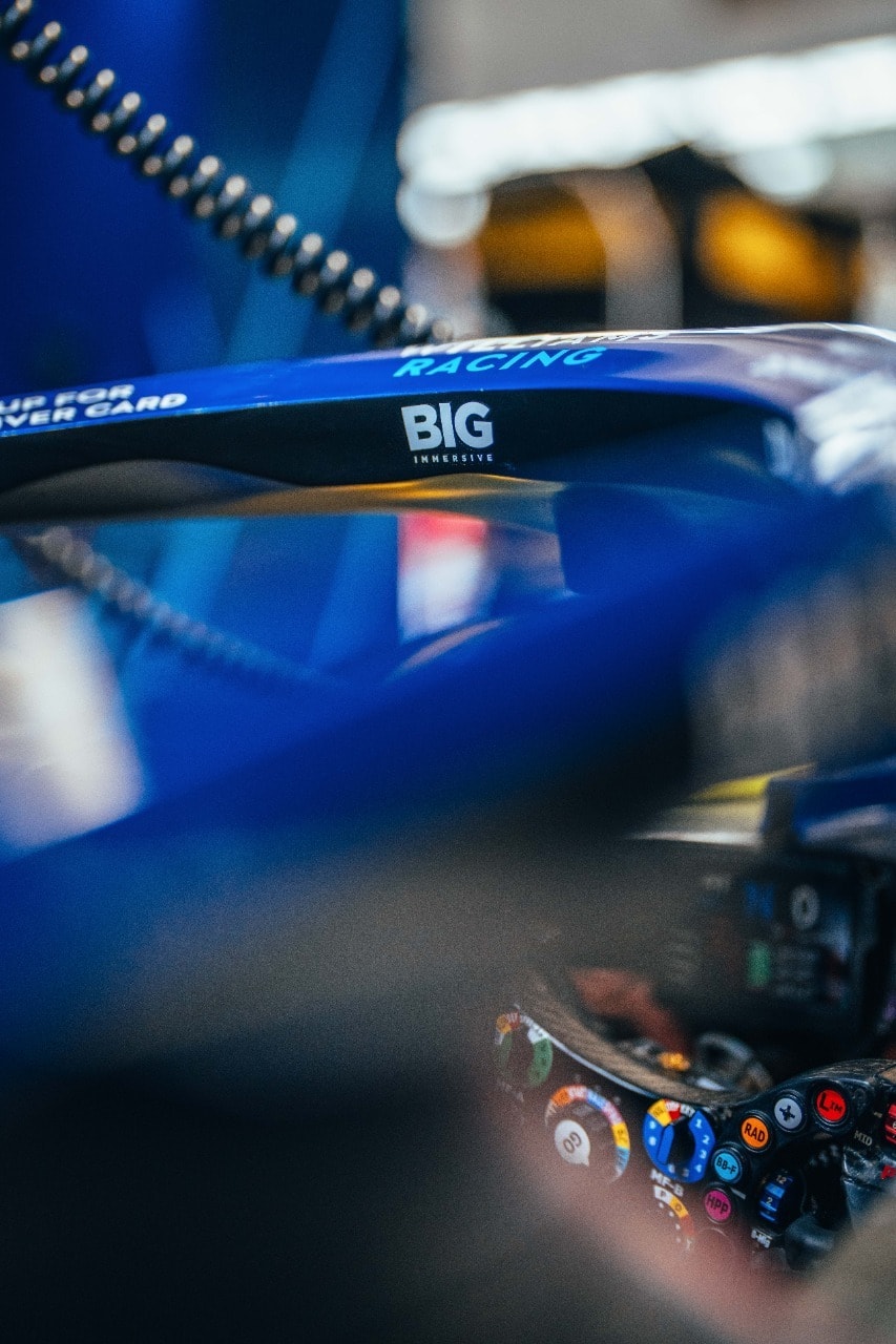 The Big Immersive wordmark on the halo of a Williams Racing Formula 1 car, directly below the Williams Racing name, with the steering wheel visible in the cockpit below.